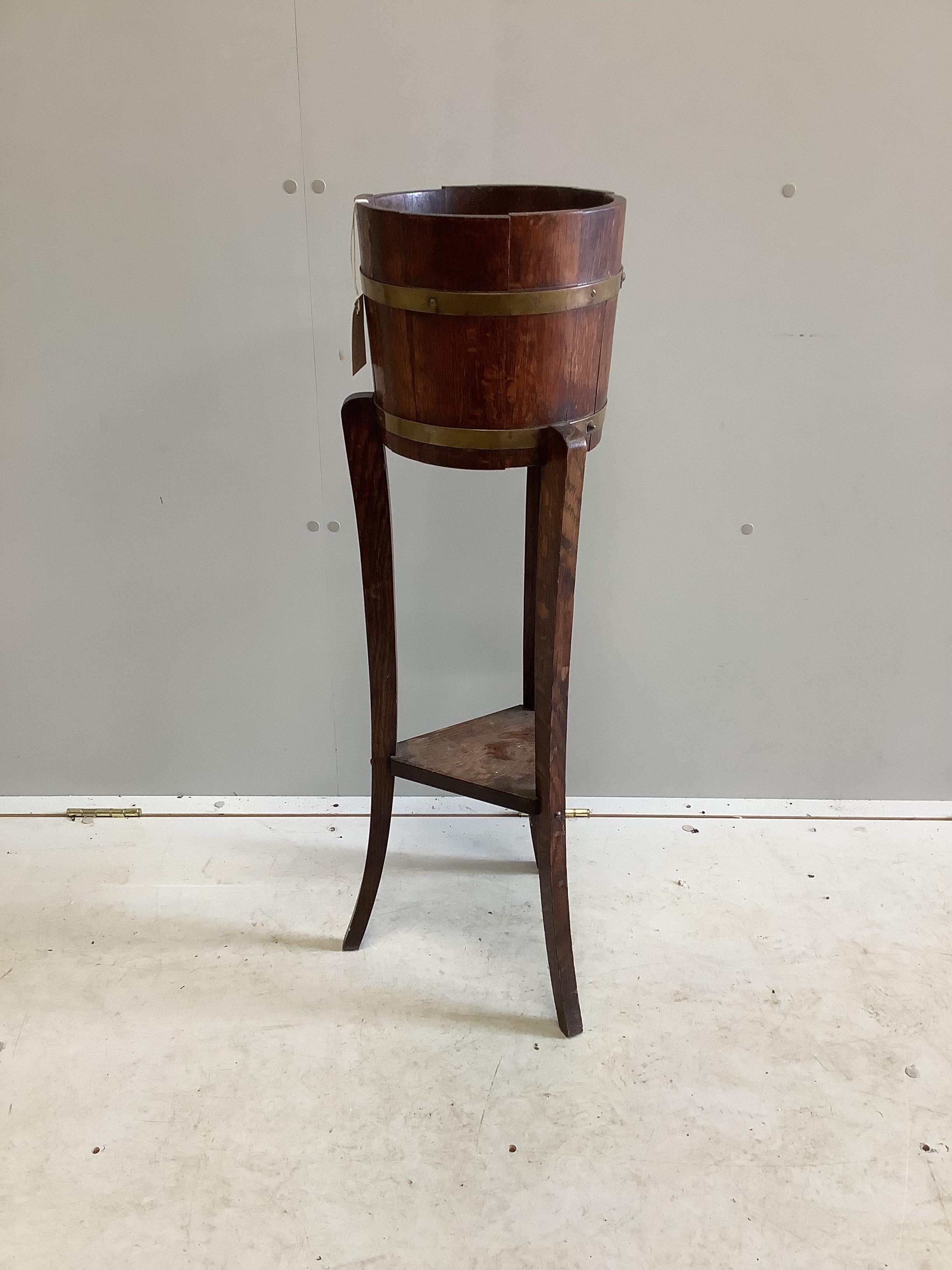 An early 20th century brass bound staved oak jardiniere, diameter 26cm, height 91cm